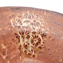 Close-up of a ceramic plate with floral patterns on a white background
