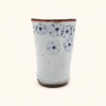 Spako Clay tumbler with blue floral patterns on a white background
