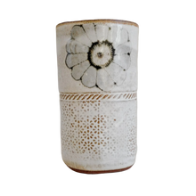 Ceramic vase with floral design on a white background