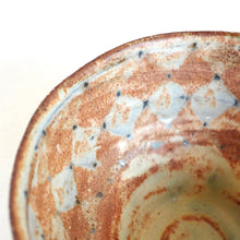 Close-up of a ceramic plate with brown and white glaze pattern