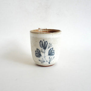Spako Clay mug. Blue line drawing of floral design, white glaze