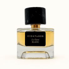 Perfume bottle with Eight & Bob Le Gant Blanc label on a off white background