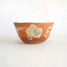 Ceramic bowl with unique texture and color on a white background