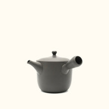 Black teapot on a white background