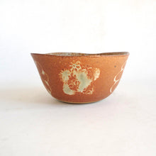 Ceramic bowl with a textured surface on a white background