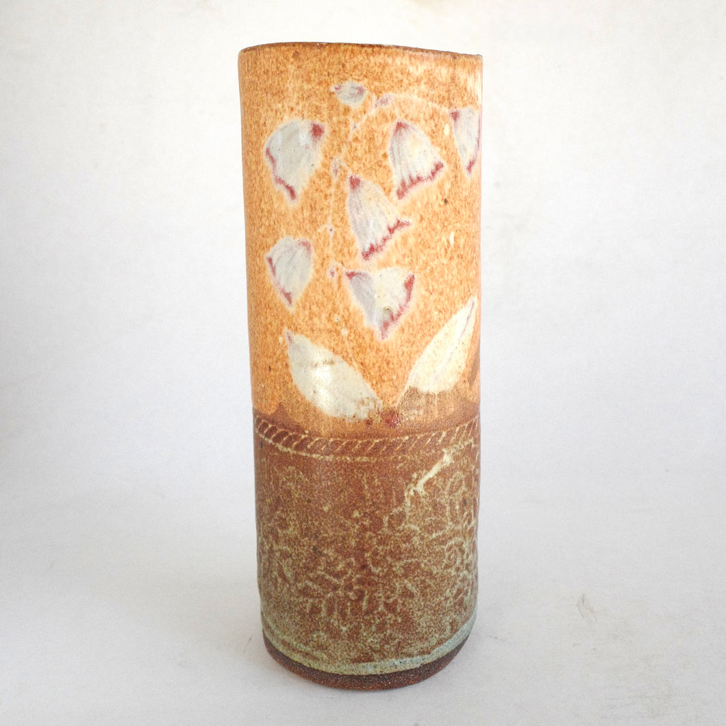 Cylindrical ceramic vase with butterfly design on a white background