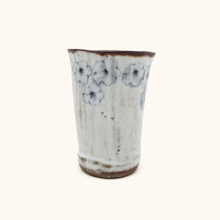 Spako Clay tumbler with blue floral patterns on a white background