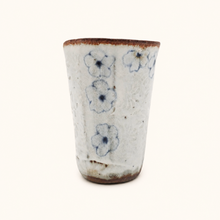 Spako Clay tumbler with blue floral patterns on a white background