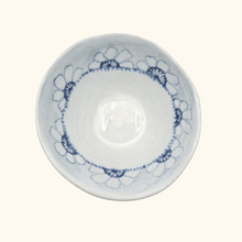 White ceramic bowl with blue floral patterns on a white background