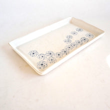 Rectangular ceramic tray with floral patterns on a white background