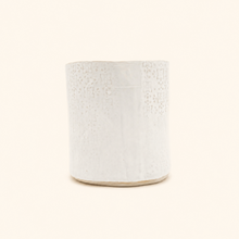 White textured ceramic pot on a white background