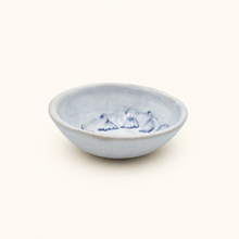 Ceramic bowl with blue floral patterns on a white background