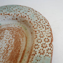 Ceramic dish with floral pattern on a white background