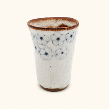 Spako Clay tumbler with blue floral patterns on a white background
