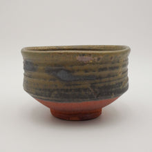 A handmade ceramic tea bowl with a textured, ribbed exterior featuring a metallic olive-green glaze, a dark gray band, and a terracotta-colored base, shown on a neutral light gray background.