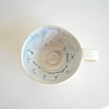 Cappuccino mug with blue flower pattern on beige background