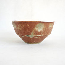 Ceramic bowl with a textured surface on a white background