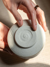 Ceramic matcha bowl in hands, close-up shot