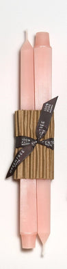 Set of two candles in blush color with brown paper wraps and brown ribbons on a white background