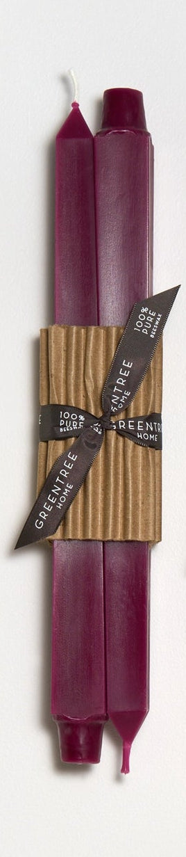 Set of two candles in wild plum color with brown paper wraps and brown ribbons on a white background
