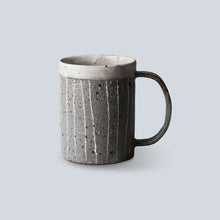 Textured ceramic mug on a light gray background