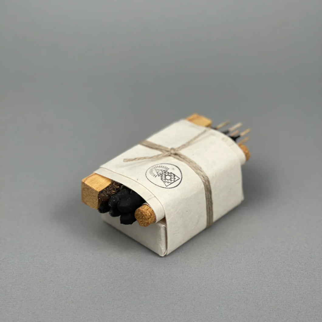 Packaged product with incense and soap bar on a gray background