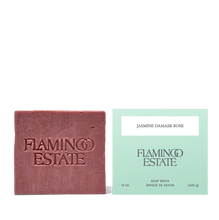 Bar of soap and its packaging with 'Flamingo Estate' branding on a white background