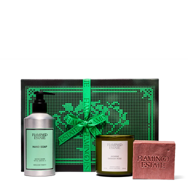 Flamingo Estate gift set with soap, candle, and bar of soap on a white background