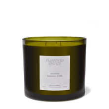 Green candle with a label on a white background