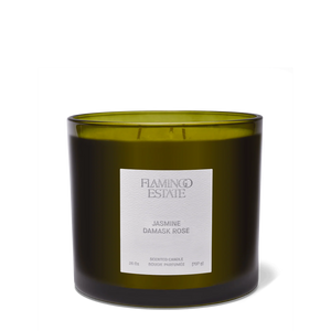 Green candle with a label on a white background