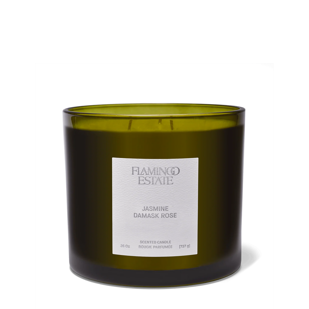 Green candle with a label on a white background