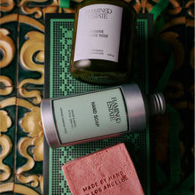 Farming Estate products including a candle, hand soap, and soap bar on a decorative tile background