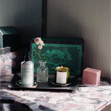 Candle and soap on a marble surface with decorative elements