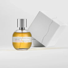 Perfume bottle with a silver cap on a light gray background