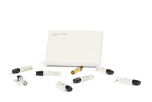 Set of small glass perfume vials with black caps on a white background