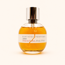 Perfume bottle with a silver cap and a visible label on a white background