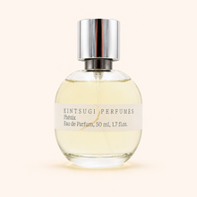 Perfume bottle with metal cap on white background