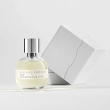 Perfume bottle with silver cap on a light gray background