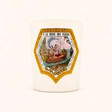 Candle with decorative label featuring artistic design and text on a white background