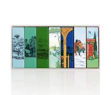 Set of colorful perfume boxes with illustrated scenes on a white background