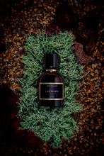 Meo Fusciuni - Last Season perfume bottle on a bed of moss and gravel 