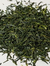 Close-up of green tea leaves on a white background