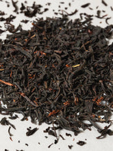 Close-up of dried black tea leaves on a white background
