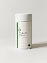 A white cylindrical canister of MORIHATA Kanayamidori green tea on a light gray background.