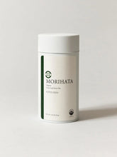 A white cylindrical canister of MORIHATA Organic Leaf-Led Green Tea, Kirishima, on a light gray background.