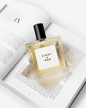 Eight & Bob The Original Perfume bottle labeled 'Eight & Bob' on an open book