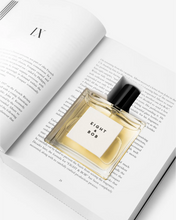 Eight & Bob The Original Perfume bottle labeled 'Eight & Bob' on an open book