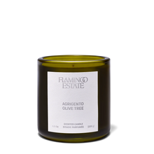 Green candle with a white label on a white background