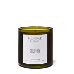 Green candle with a white label on a white background