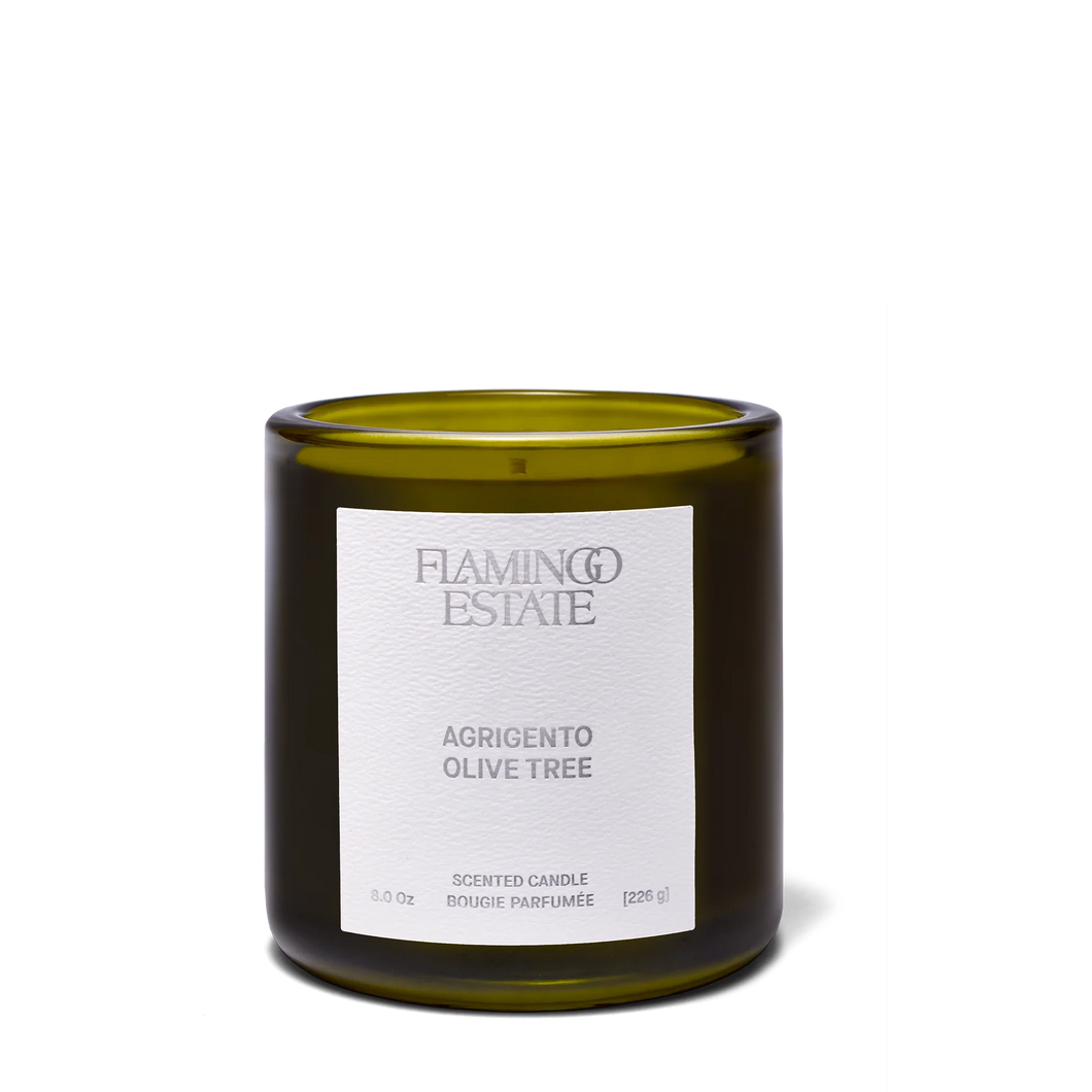 Green candle with a white label on a white background